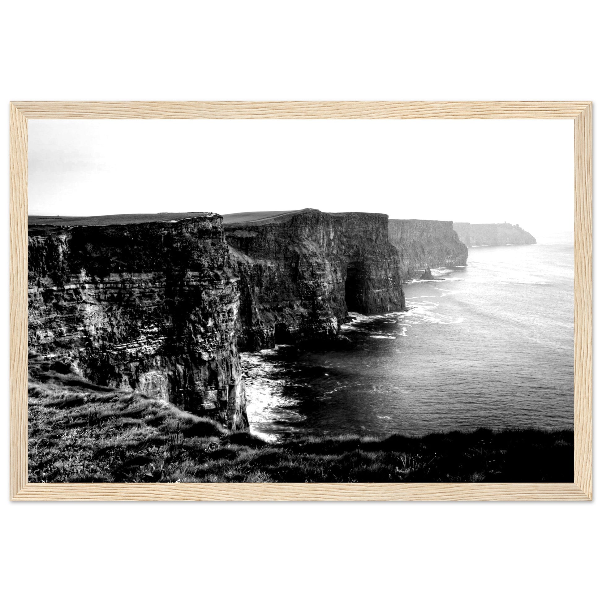 Monochrome photo of Cliffs of Moher, framed elegantly. Captures rugged beauty, contrasts. Minimalist frame complements decor. Evokes awe.