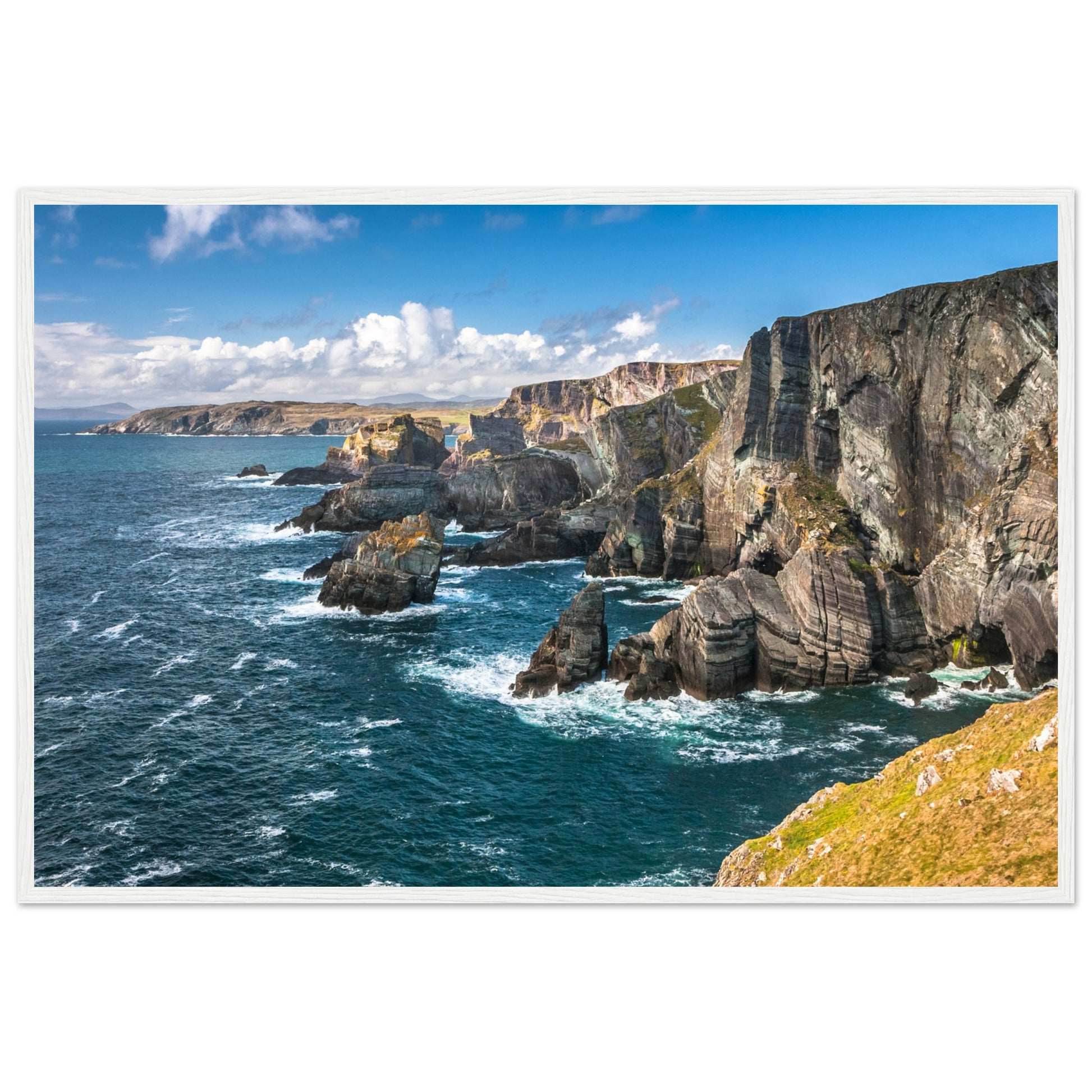 Captivating white framed print of Mizen Head, County Cork, Ireland. Features dramatic Atlantic coast, towering cliffs, and raw power of ocean. Perfect decor for nature lovers.