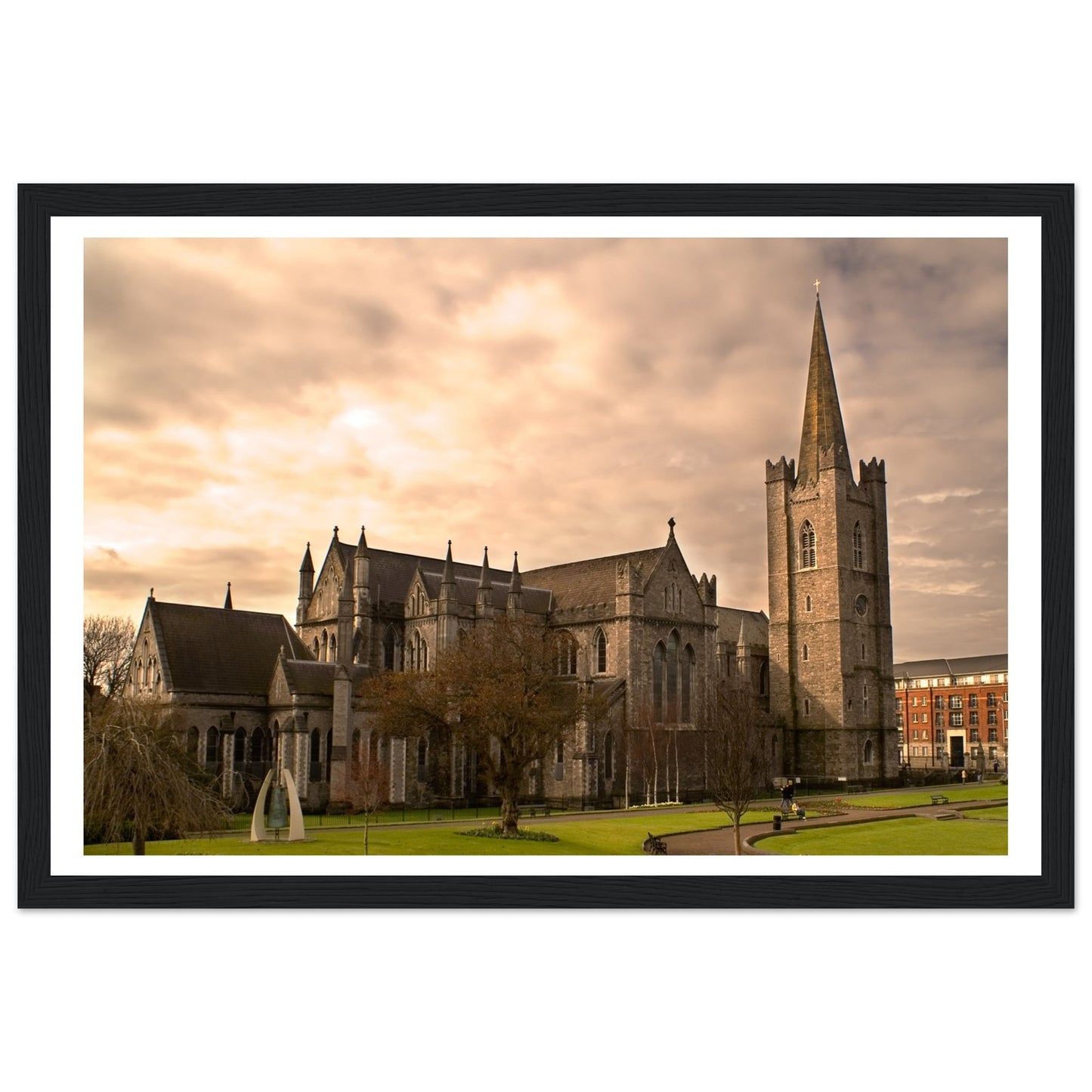 Framed print of St. Patrick's Cathedral in Dublin, showcasing its majestic Gothic architecture with detailed spires and intricate stonework. The serene scene captures the historic beauty of Ireland's largest cathedral, perfect for enhancing any living space.