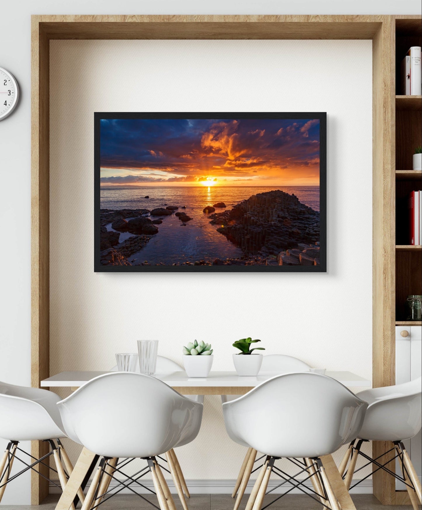 Framed art print of a mesmerizing sunset at Giant's Causeway, showcasing iconic basalt columns against a sky painted with warm hues. The scene captures nature's beauty and tranquility, adding a sophisticated touch to home or office decor. Perfect for any art lover.